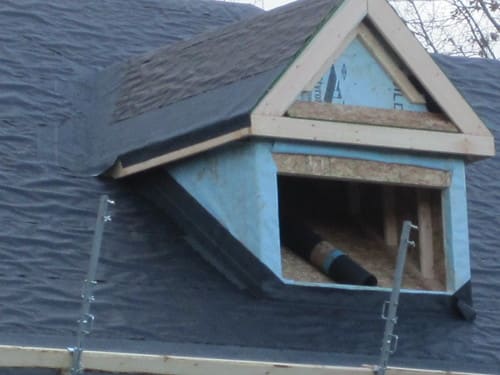 Dormer roof detail on a shingle roof