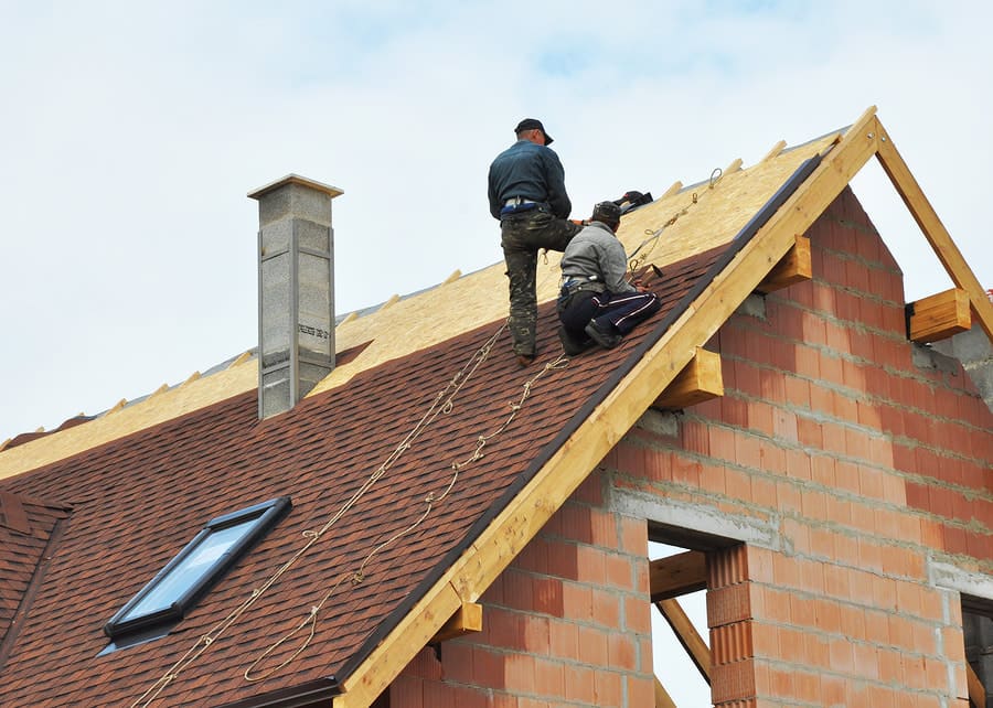 Roof crew working near a ridge